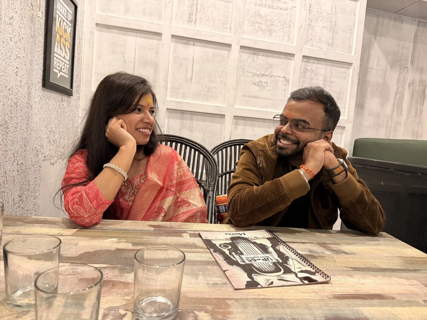 The two of us at a restaurant table, leaning on our hands