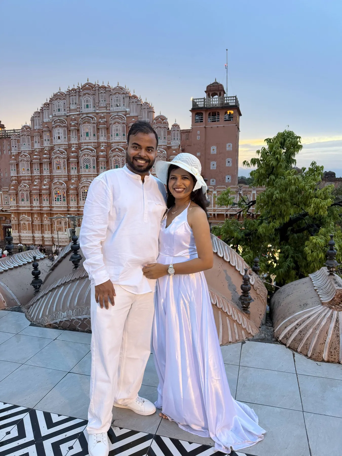 The two of us in white on a rooftop opposite Hawa Mahal at dusk