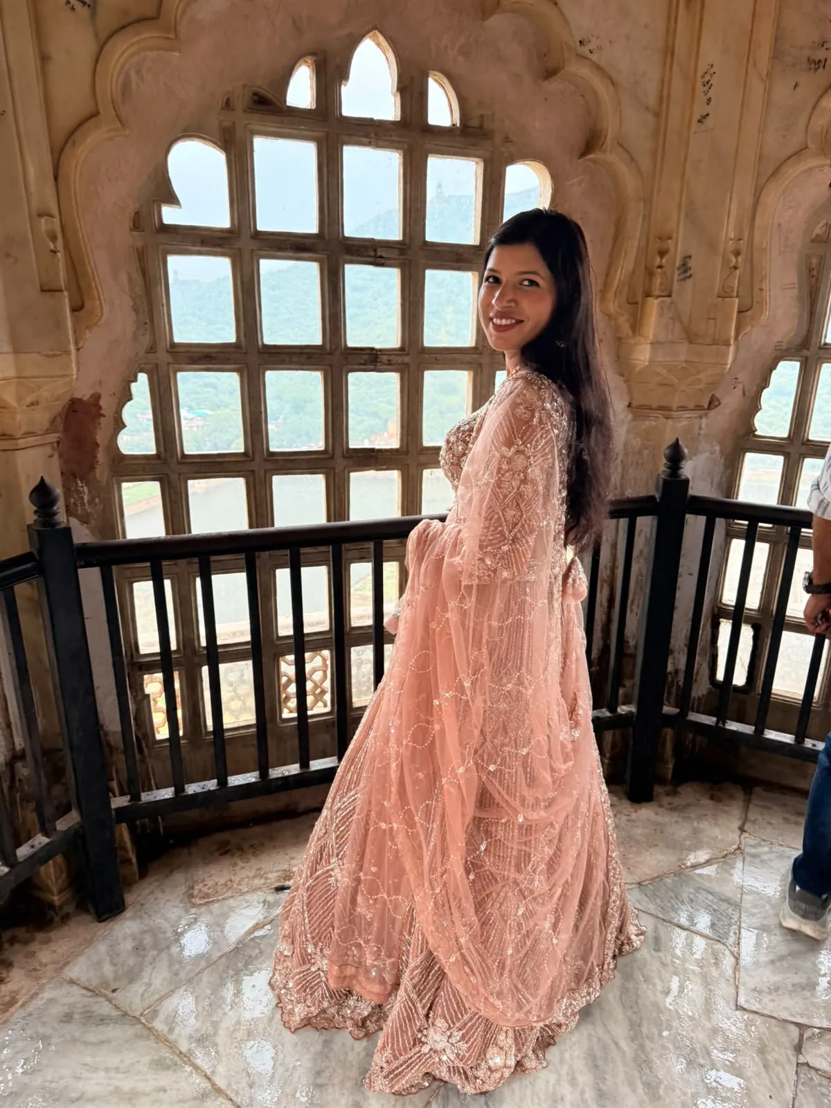 Kanchan at a latticed window inside Amer Fort