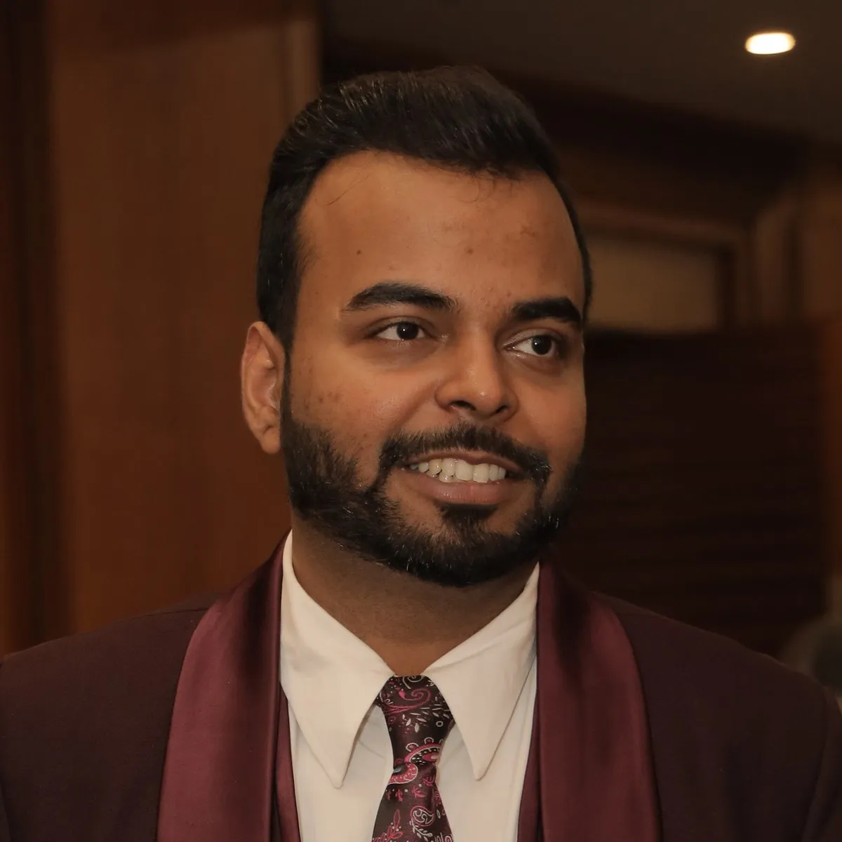 Lucky Sahani in a maroon suit
